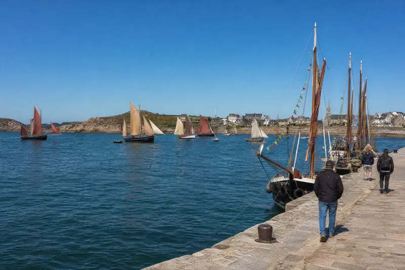 La Fête de la Mer : vieux gréements aux voiles rouges dans la baie, vus depuis le quai.